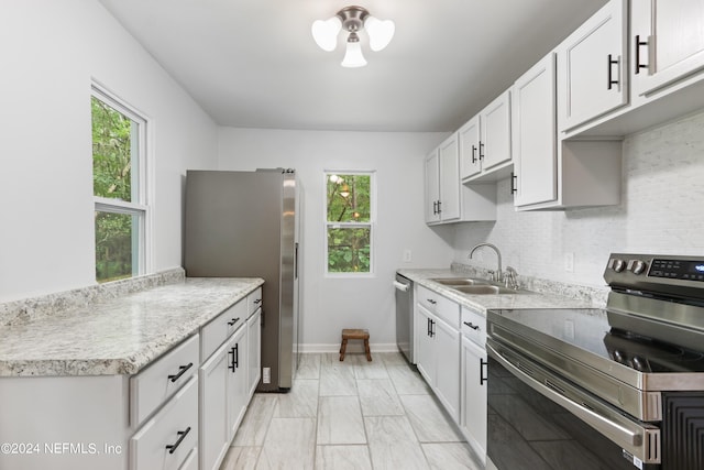 kitchen featuring a healthy amount of sunlight, white cabinetry, and stainless steel appliances