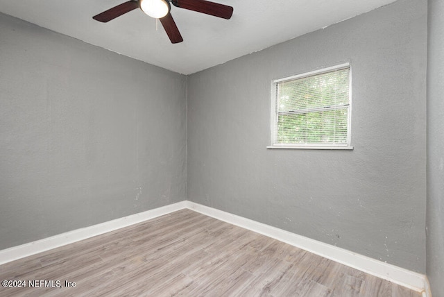 spare room featuring hardwood / wood-style flooring and ceiling fan