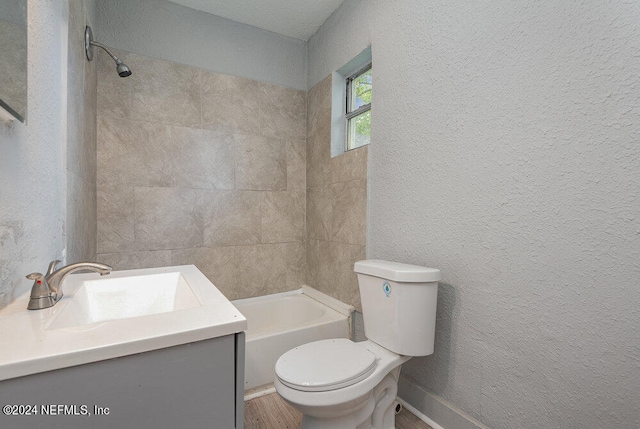 full bathroom with tiled shower / bath combo, vanity, toilet, and wood-type flooring