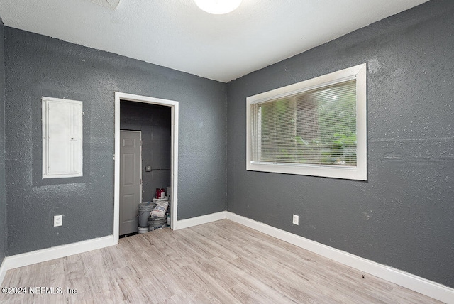 unfurnished bedroom featuring electric panel and wood-type flooring