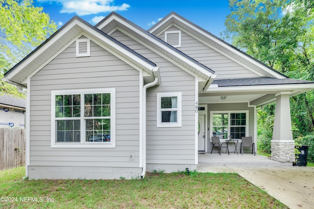 rear view of property with a yard and a patio