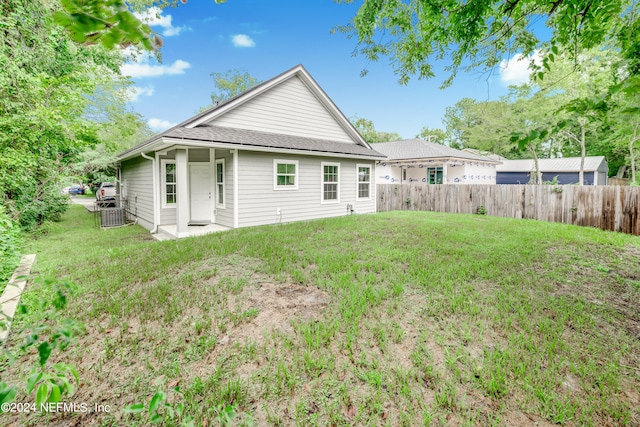 rear view of property with a lawn