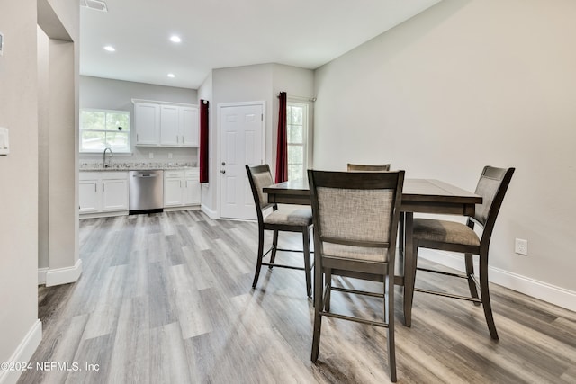 dining room with light hardwood / wood-style flooring and sink