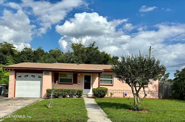 ranch-style home with a garage and a front lawn