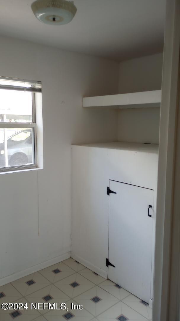 clothes washing area with baseboards