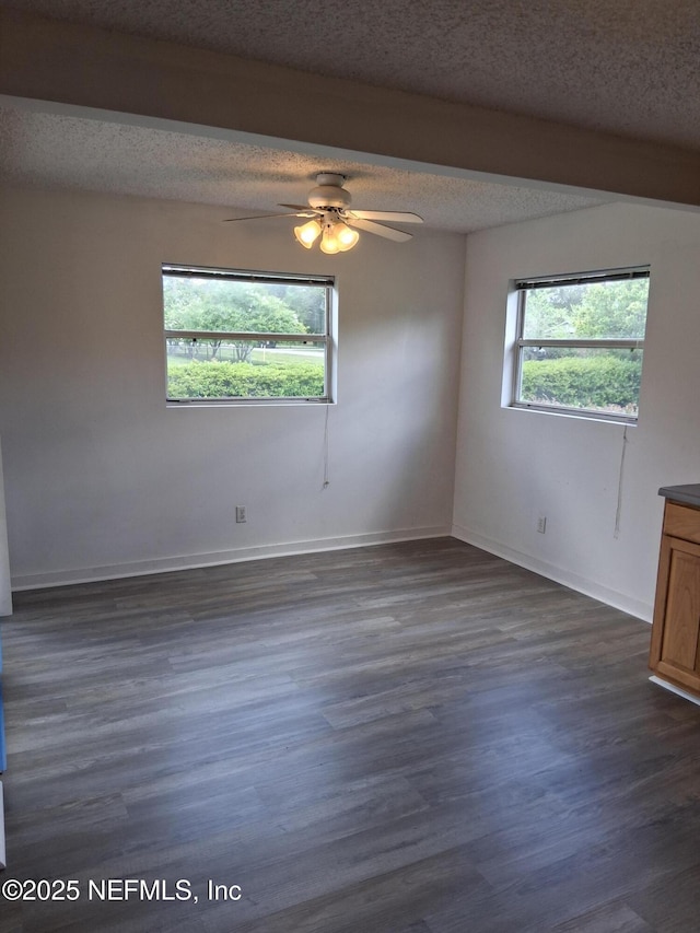 85166 Radio Ave, Yulee, FL 32097 - unfurnished room with a textured ceiling, a ceiling fan, dark wood-style floors, and baseboards