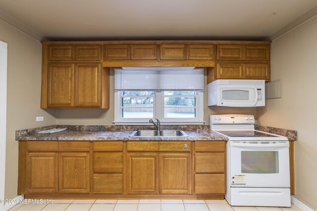 kitchen featuring ornamental molding, light tile patterned floors, white appliances, and sink