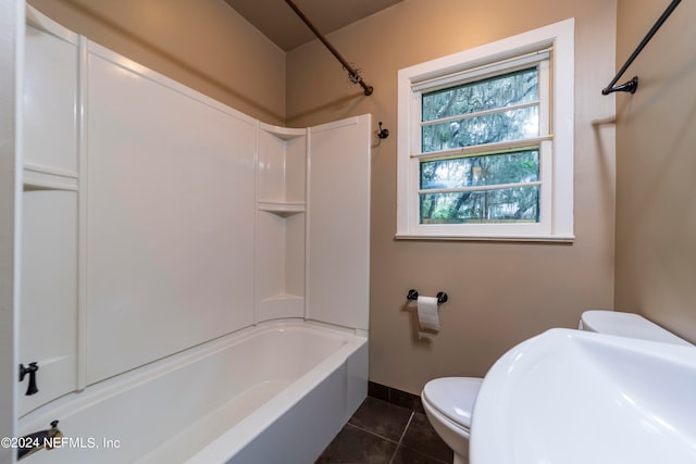 bathroom with toilet, tile patterned floors, and washtub / shower combination