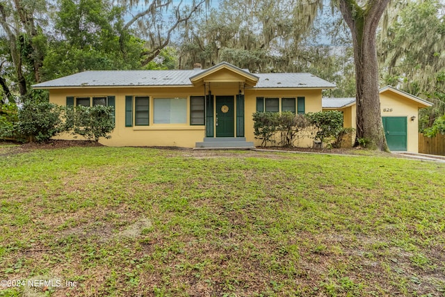 ranch-style home with a front lawn and a garage