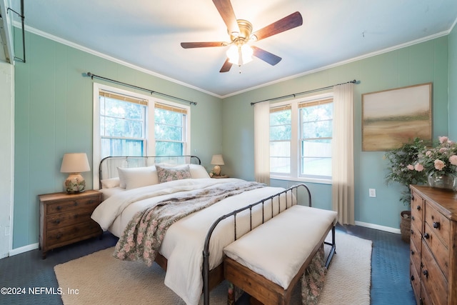 carpeted bedroom featuring crown molding and ceiling fan