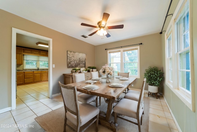 dining room with sink, light tile patterned floors, and ceiling fan