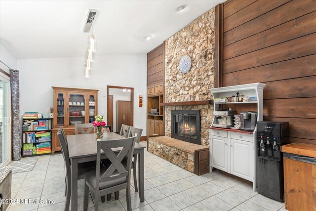 tiled dining area with a fireplace