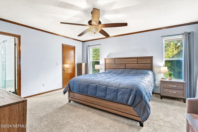 bedroom featuring ceiling fan, crown molding, and light colored carpet