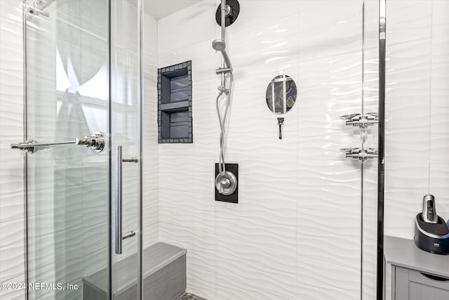 bathroom with a shower with door