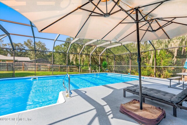 view of pool featuring a patio and glass enclosure