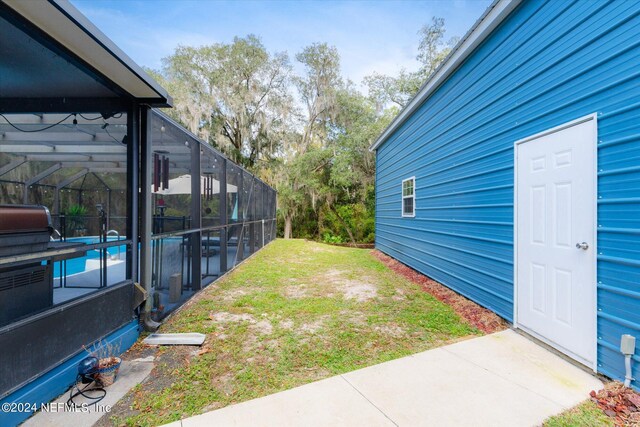 view of yard with glass enclosure