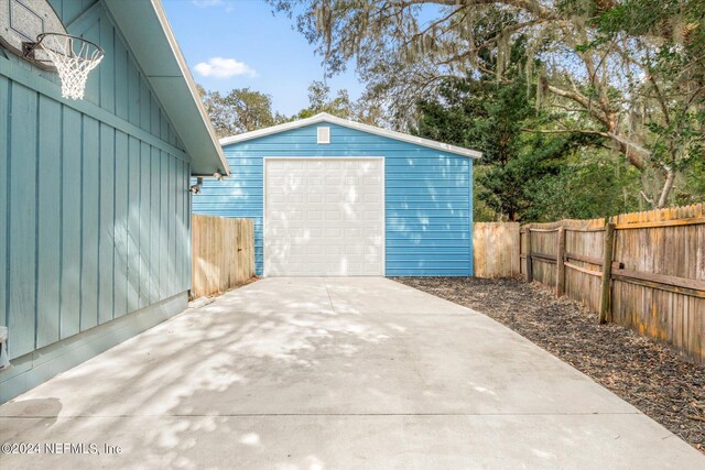 exterior space featuring a garage and an outdoor structure