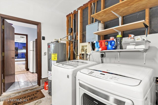 washroom featuring water heater and separate washer and dryer