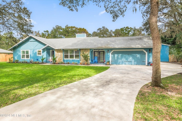 ranch-style house featuring a front lawn and a garage