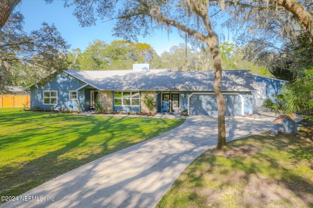 ranch-style house with a front yard and a garage