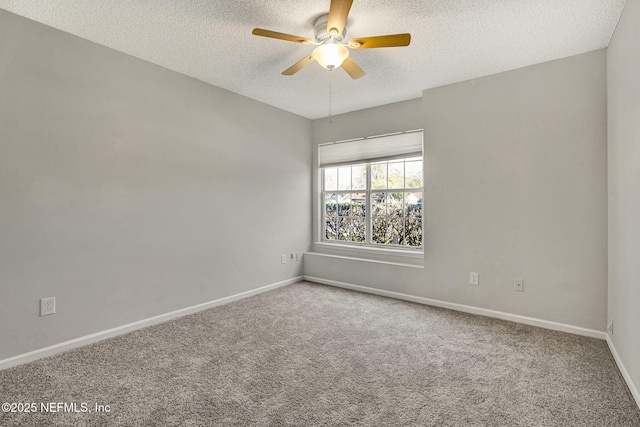 carpeted empty room featuring ceiling fan and a textured ceiling