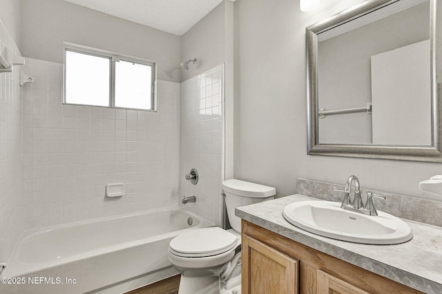 full bathroom with hardwood / wood-style flooring, vanity, toilet, and tiled shower / bath combo