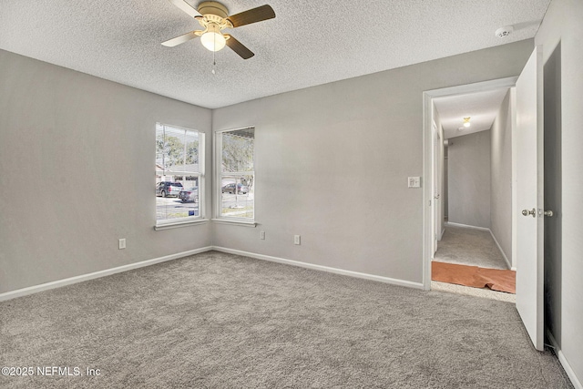 empty room with carpet, a textured ceiling, and ceiling fan