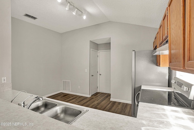 kitchen with dark wood-type flooring, sink, stainless steel range with electric cooktop, and a textured ceiling