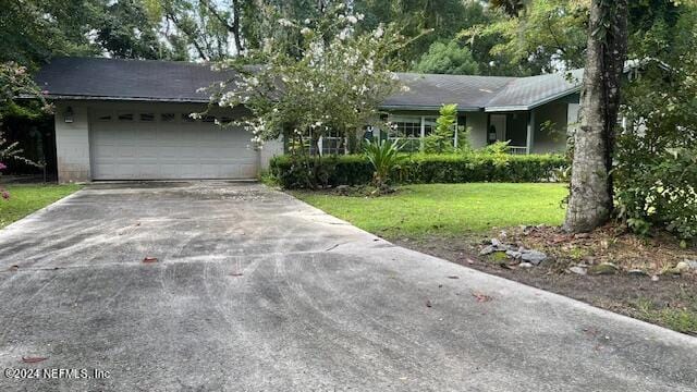 ranch-style home featuring a garage and a front yard