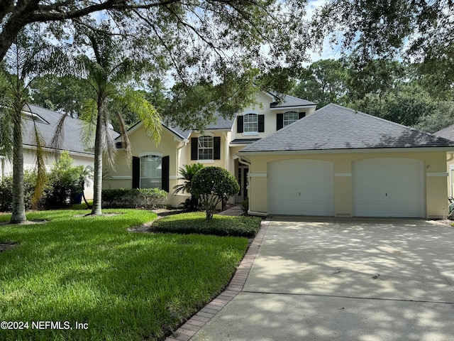 view of front of house featuring a front yard and a garage