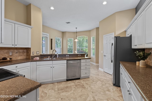 kitchen with dishwasher, backsplash, sink, and white cabinetry