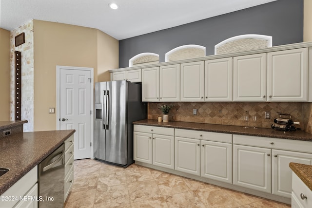 kitchen featuring white cabinetry, stainless steel appliances, and tasteful backsplash