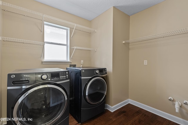 laundry room featuring dark wood-type flooring, a textured ceiling, and separate washer and dryer