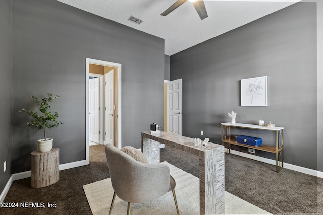 office area with dark carpet, a textured ceiling, and ceiling fan