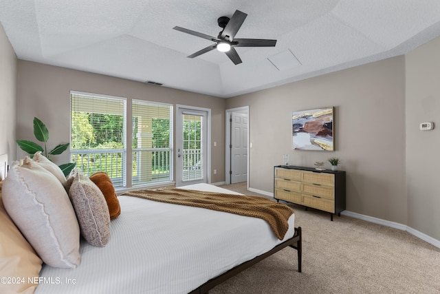 carpeted bedroom with a textured ceiling, lofted ceiling, ceiling fan, and access to exterior