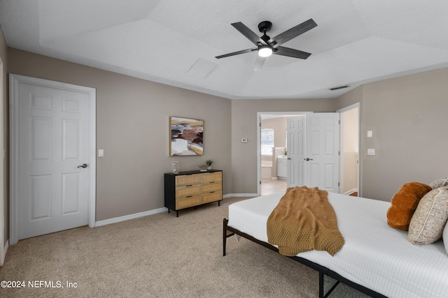 bedroom featuring carpet, connected bathroom, vaulted ceiling, and ceiling fan