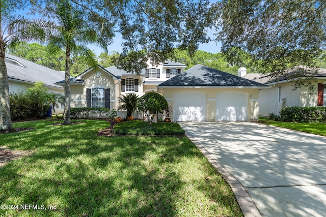 view of front of property with a garage and a front yard