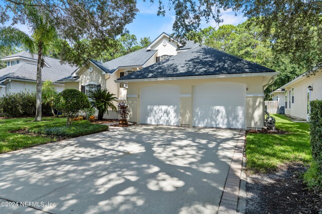 view of front facade with a garage and a front yard