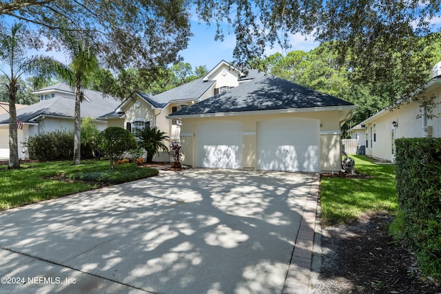 view of front of property with a front yard and a garage