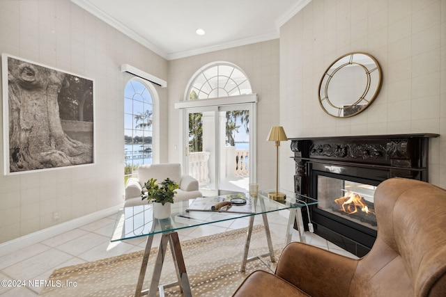 living room with light tile patterned floors, a multi sided fireplace, crown molding, and a water view