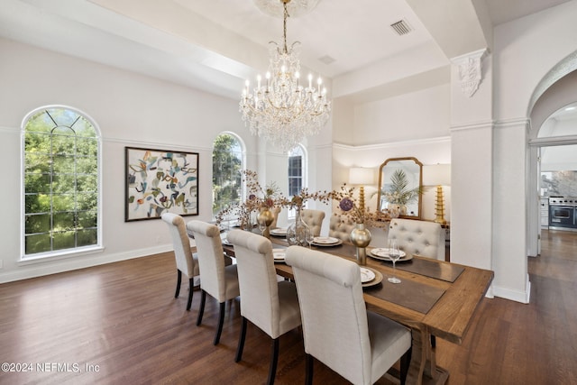 dining space featuring a notable chandelier and dark hardwood / wood-style flooring