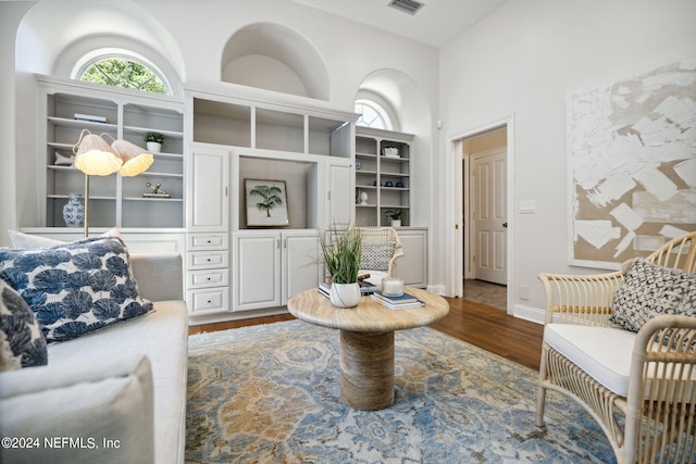 living room featuring hardwood / wood-style floors and high vaulted ceiling