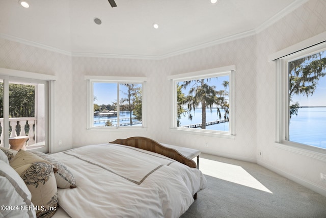 bedroom with multiple windows, a water view, ornamental molding, and carpet flooring