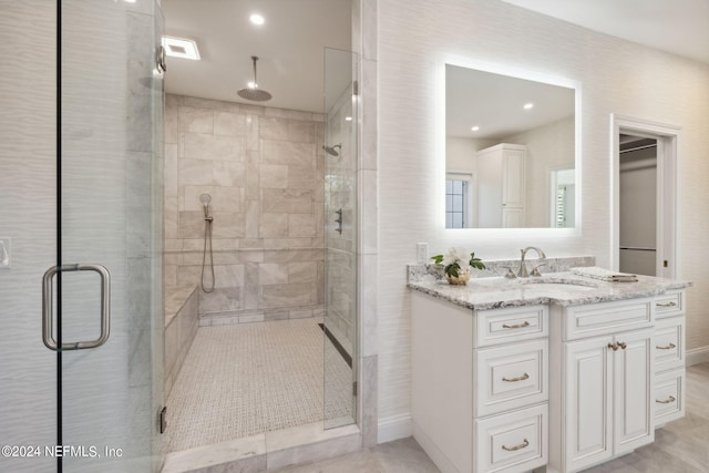 bathroom featuring vanity and a shower with shower door