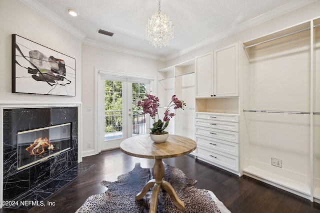 spacious closet featuring an inviting chandelier, a fireplace, and dark hardwood / wood-style floors