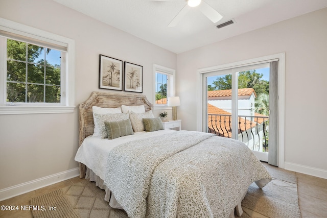 tiled bedroom featuring ceiling fan, multiple windows, and access to outside