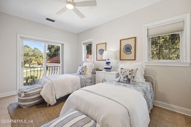 tiled bedroom with ceiling fan and access to exterior