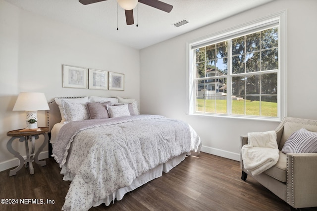 bedroom with ceiling fan and dark wood-type flooring