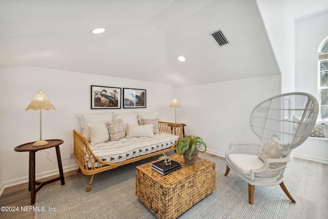 living room featuring wood-type flooring and lofted ceiling