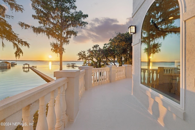 exterior space featuring a balcony and a water view